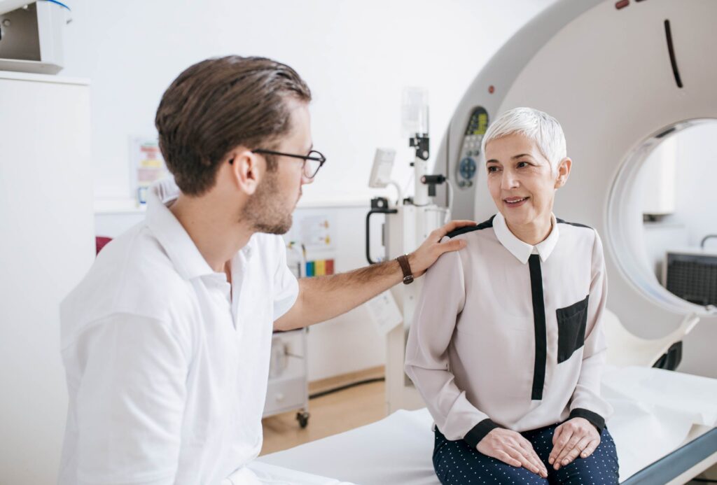 A patient talks with her doctor about getting a CT scan to help detect cancer.